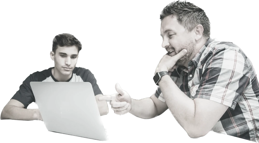 Two men collaborating over a laptop